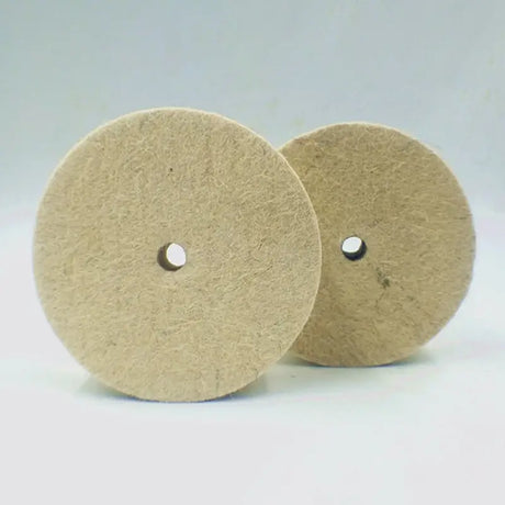 two beige buff pads on a white background