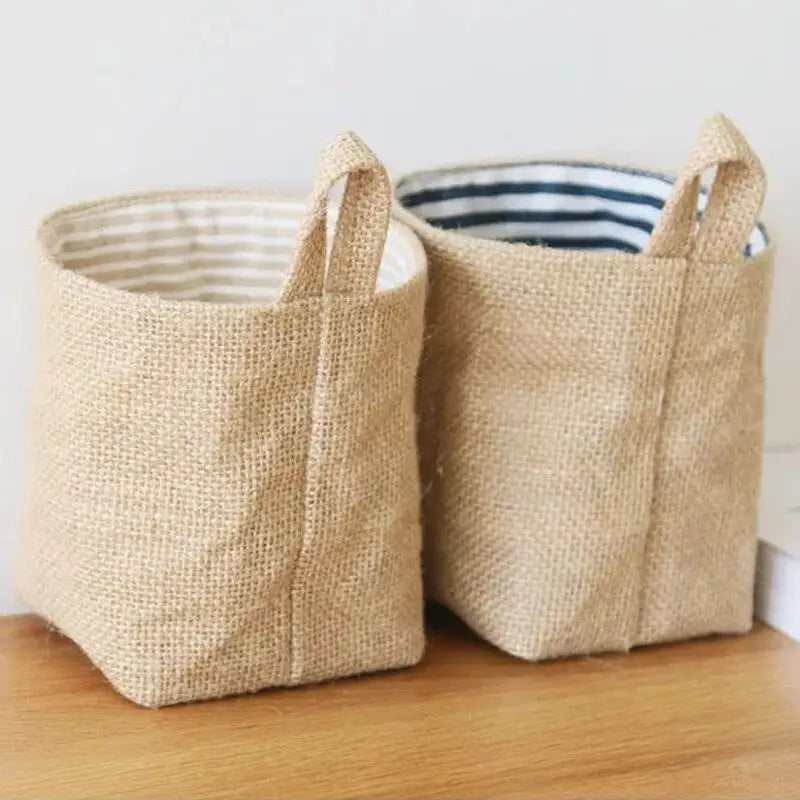 two jute baskets with handles on a wooden table