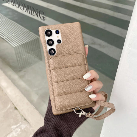 Beige leather phone case with multiple camera cutouts and a wrist strap.