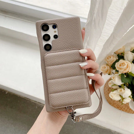 Beige leather phone case with multiple camera cutouts and a wrist strap.