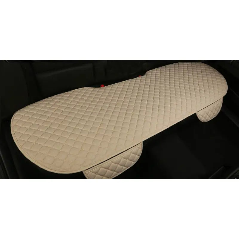 the car floor mat is made from a beige leather material