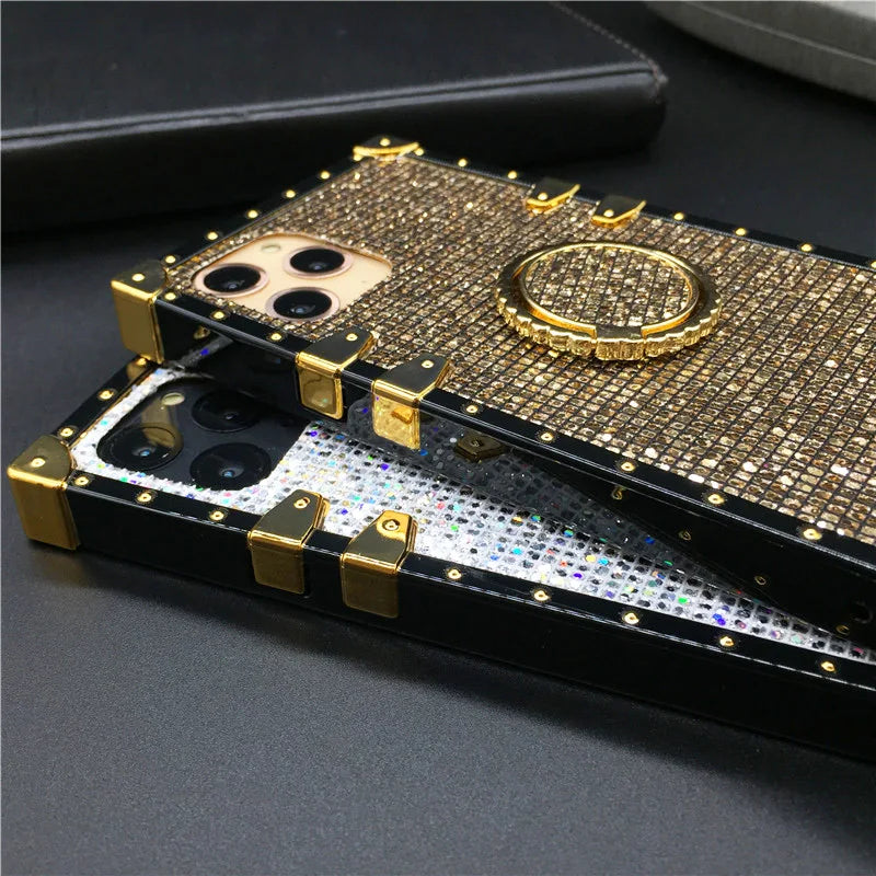 Bejeweled gold-colored smartphone case with a ring holder attachment.