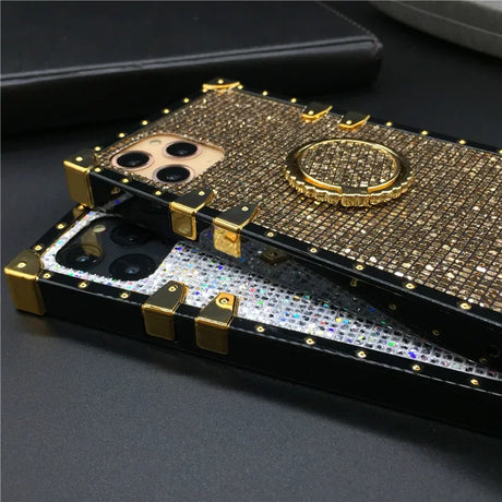 Bejeweled gold-trimmed smartphone case with a ring holder.