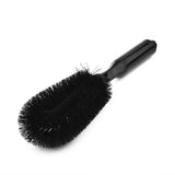 a black brush with a black handle