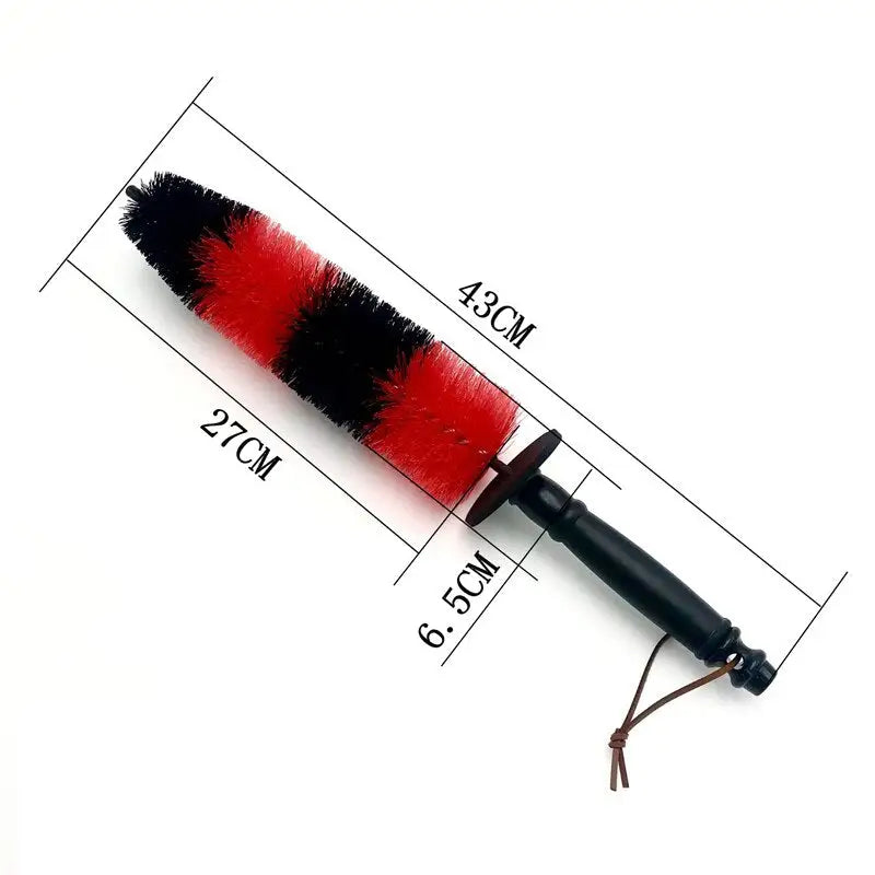 a red and black brush with a black handle