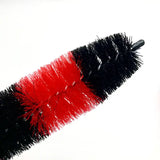 a black and red brush with a red handle