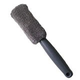 a black brush with a black handle