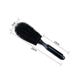 the large brush is a black brush with a black handle