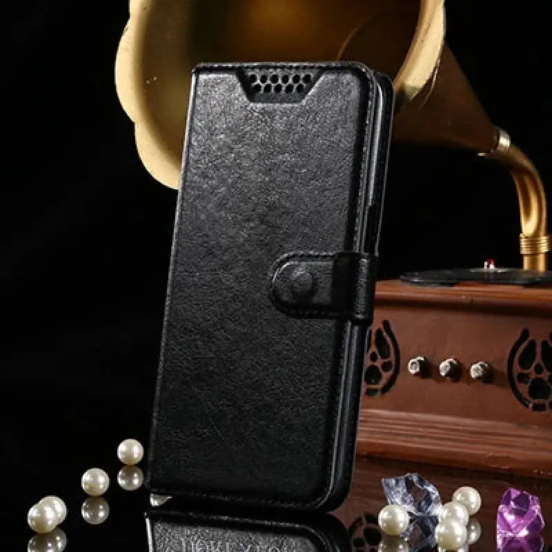 a black case with pearls and a gold gramphone