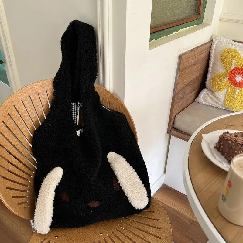 a black cat sitting on top of a wooden chair