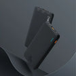 The back of a black cell phone with a black background