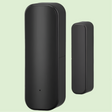 Black cylindrical smart home sensor or security device with a smaller companion unit.