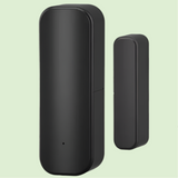 Black cylindrical smart home sensor or security device with a smaller companion unit.