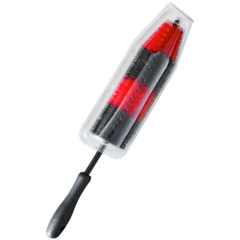 a red and black plastic brush with a black handle
