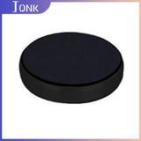 a black hockey puck with a white background