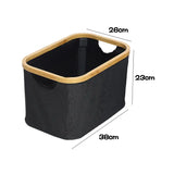 a black and gold storage basket with a wooden handle
