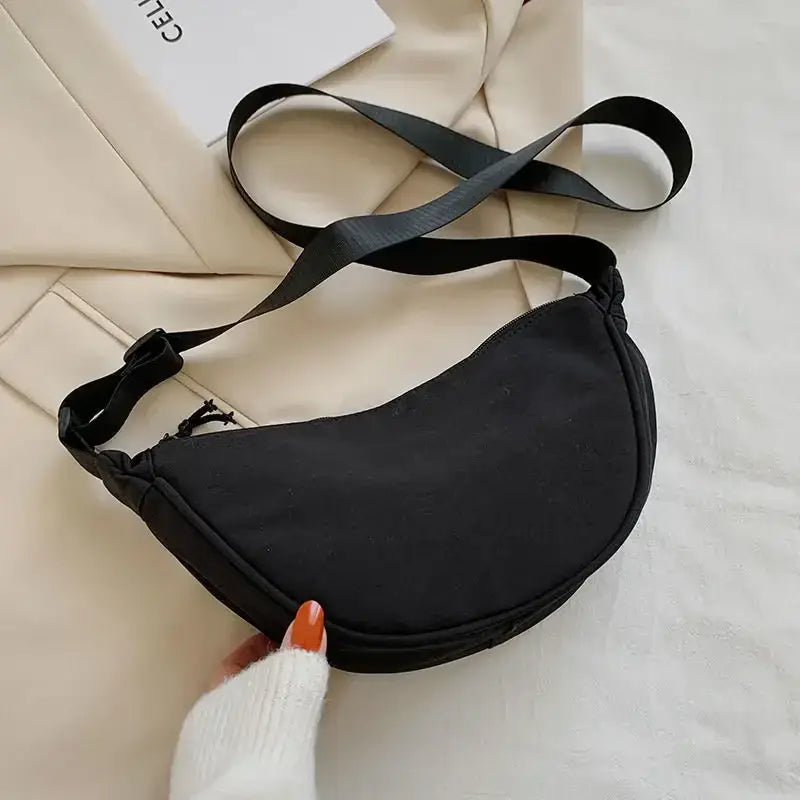 a black fanny bag with a white sweater and white socks