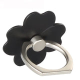 a black flower shaped ring with a silver ring