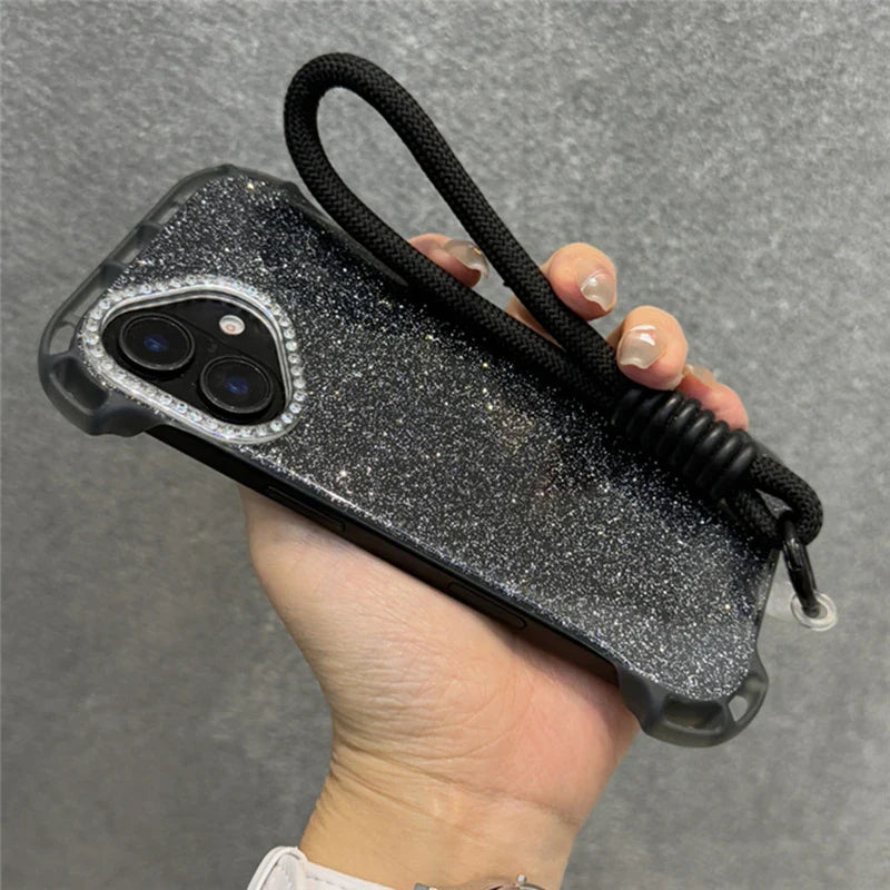 Black glitter phone case with a camera lens adorned with rhinestones and an attached black rope wristlet.