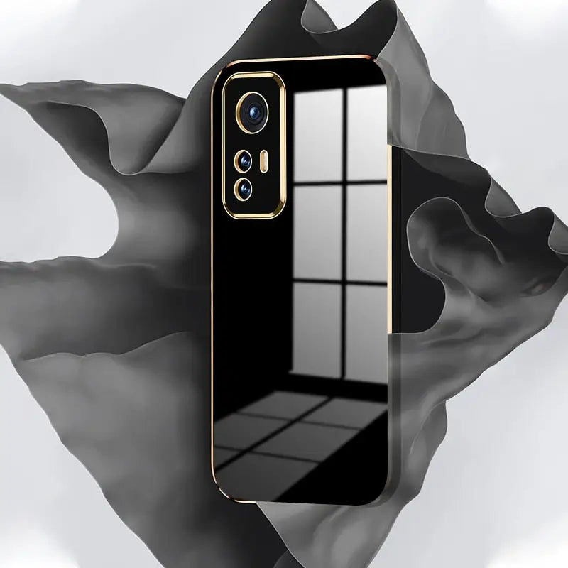 a black and gold iphone case with a mirror