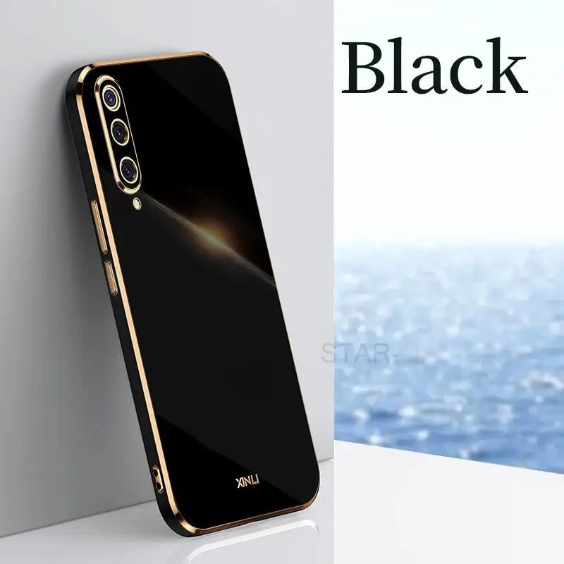the back of a black iphone case with a gold border