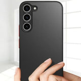 The back of a black iphone case with a hand holding it