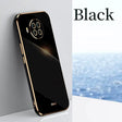 the back of a black phone with a gold frame