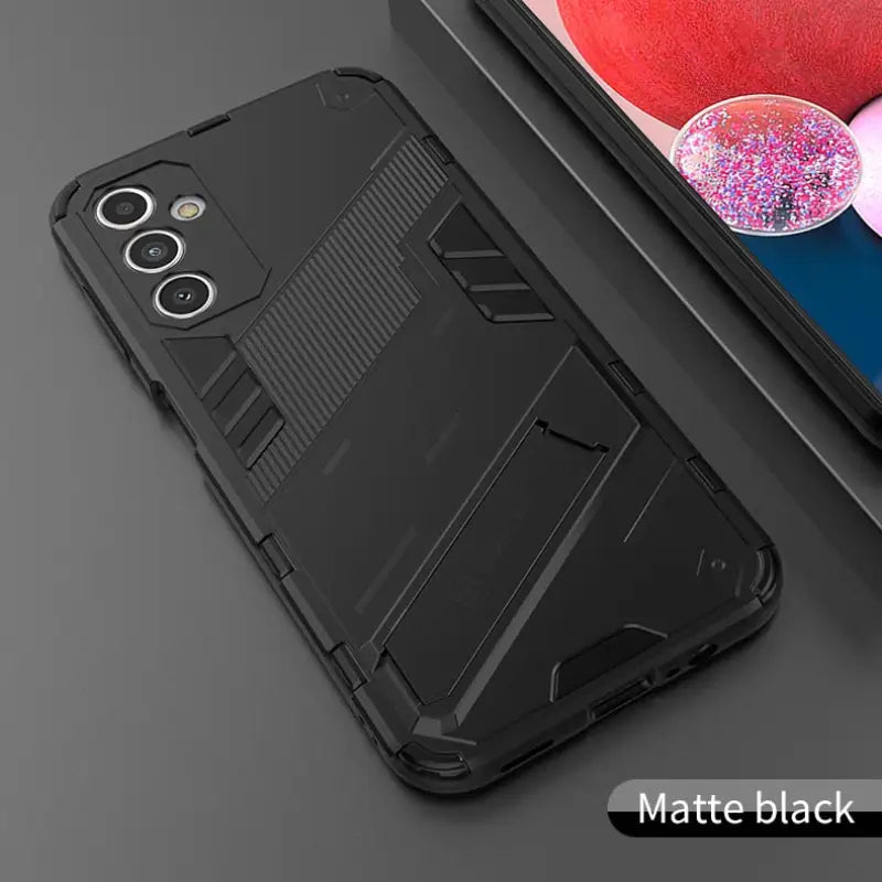 the back of a black iphone case with a phone in the background