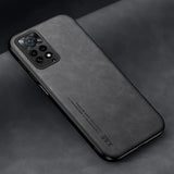 The back of a black iphone case on a black surface