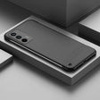 the back of a black iphone case on a white surface