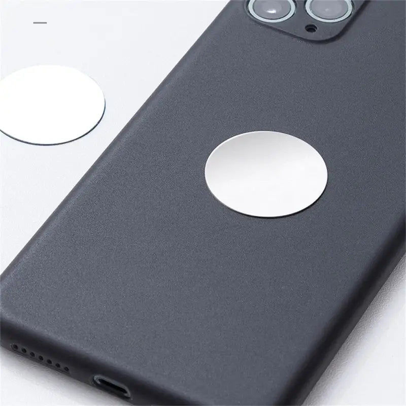 the back of a black iphone case with a white circle on it
