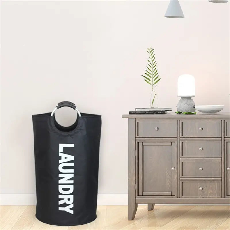 a black laundry bag next to a grey laundry bag