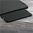 the back of a black leather case with a black leather cover