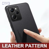 The back of a black leather case with a hand holding it
