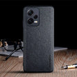 the back of a black leather case with a pen and glasses on it