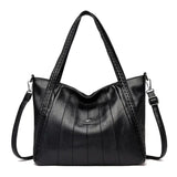 a black leather handbag with braid detailing