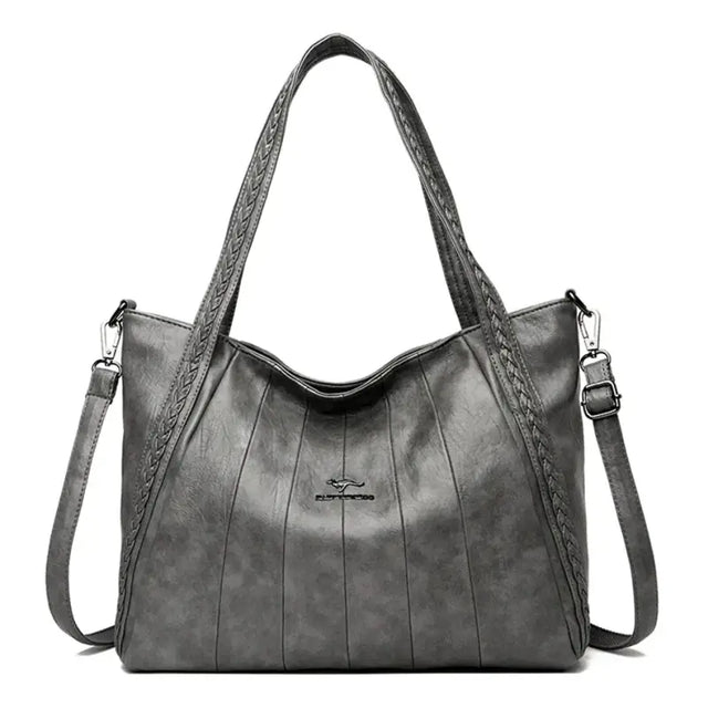 a black leather handbag with braid detailing