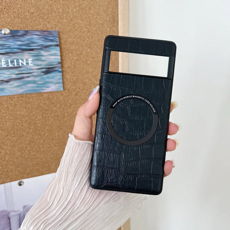 Black leather phone case with a circular embossed design held in a hand.