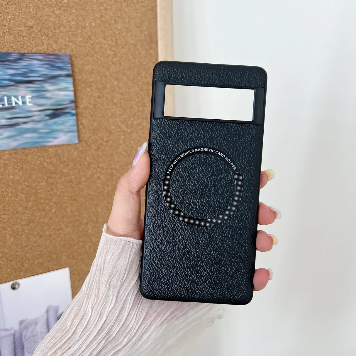 Black leather phone case with a circular cutout and a rectangular window.