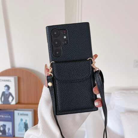 Black leather phone case with a camera cutout and attached strap.