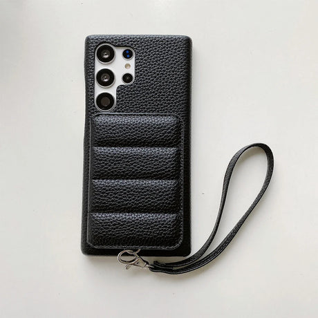 Black leather smartphone case with multiple camera cutouts and a wrist strap.