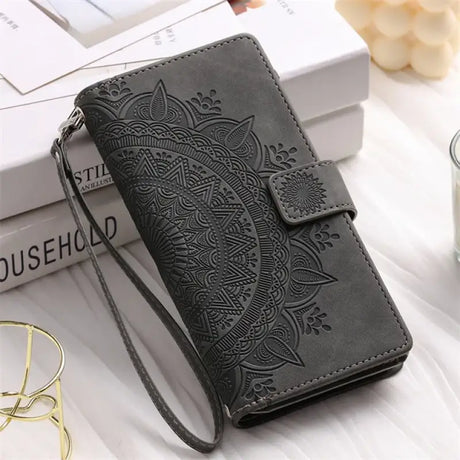 A black leather wallet case with a flower design