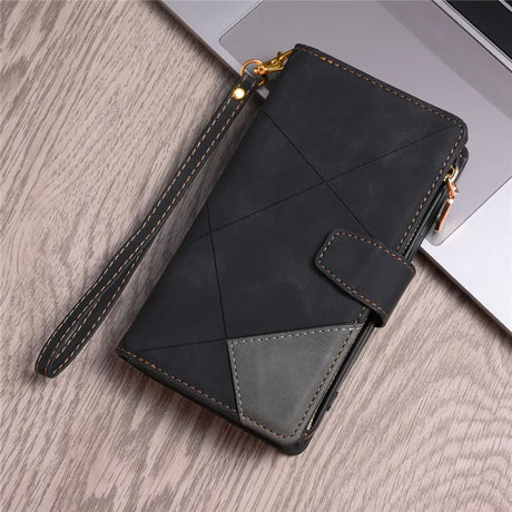 Black leather wallet with geometric stitching and a wrist strap.