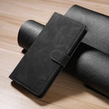 Black leather wallet or phone case with a clasp closure.