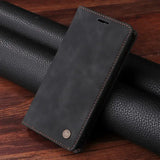 Black leather wallet-style phone case with a subtle logo on the front.