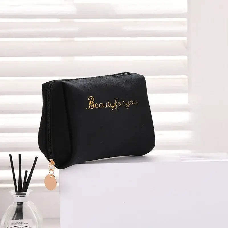 a black makeup bag with the words beauty on it