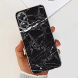 a woman holding a black marble phone case