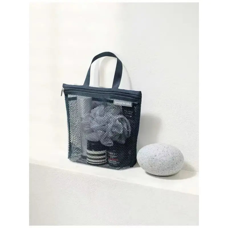 a black mesh bag with a ball on the side