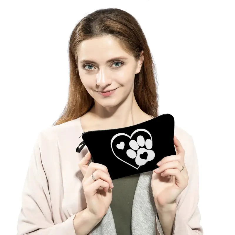 a woman holding a black and white heart shaped pillow