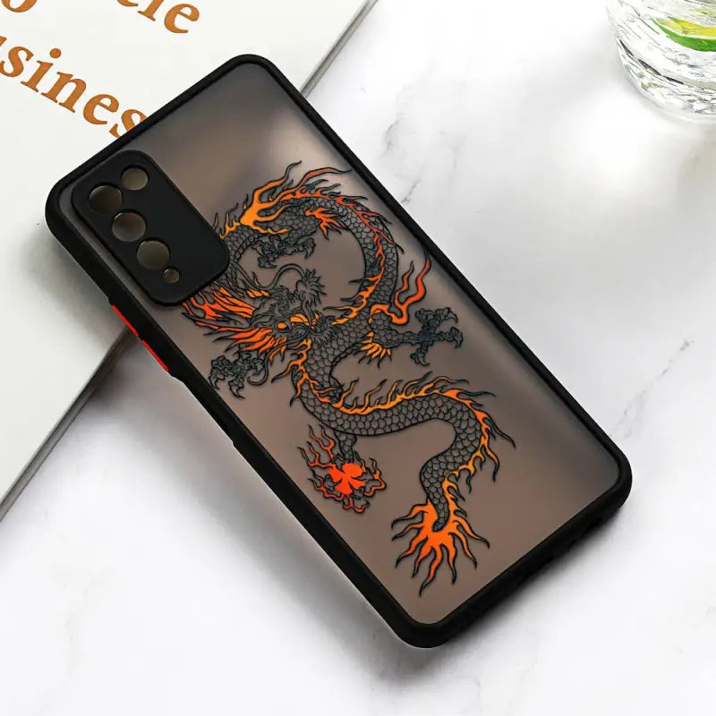 a black dragon phone case with orange flames on it
